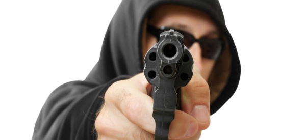 man  shoots a gun, gangster, focus on the gun, isolated on white