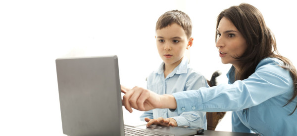 boy leaning to use computer