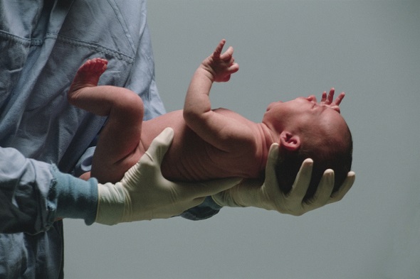 Doctor holding newborn baby