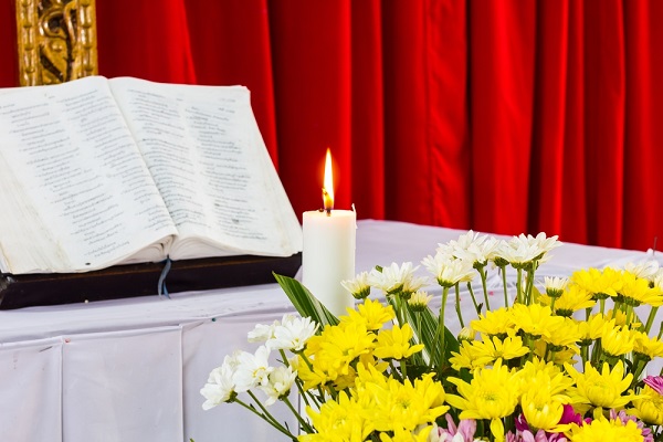 bible open on a table with candle