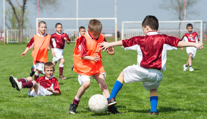 children playing soccer on the sports field